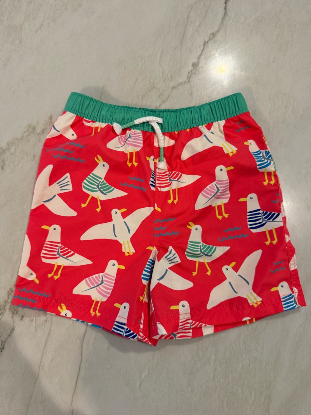 Boden Kids Seagull Print Red Swim Shorts with Green Waistband